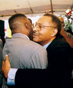 Roland Burris hugging supporter.