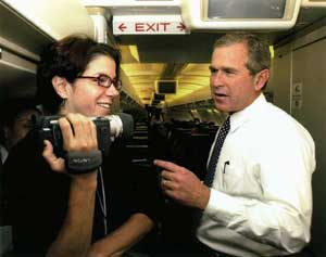 Pelosi and Bush standing together.