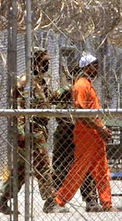 A prisoner being escorted by guards.